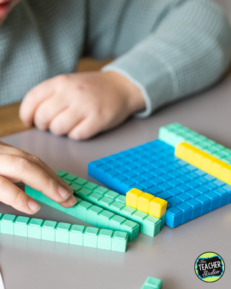 Child working with base 10 blocks to work on place value